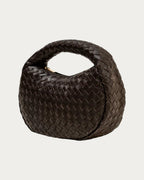 ALEO Laluna Mini Woven Shoulder Bag in Fondant, three-quarter view showing the woven handle, on soft stone background