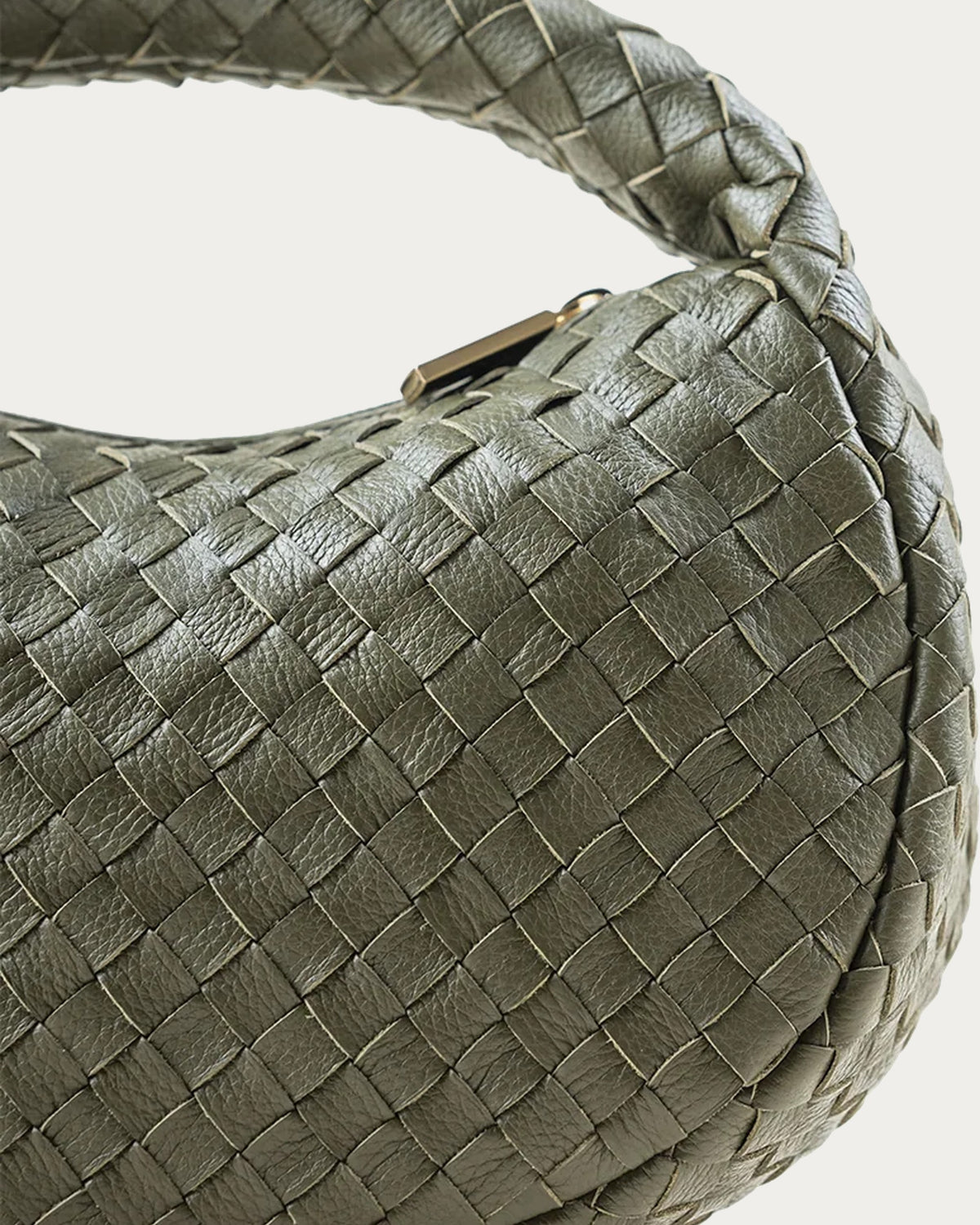 ALEO Laluna Mini Woven Shoulder Bag in Olive, close-up of the handwoven leather and gold zip pull