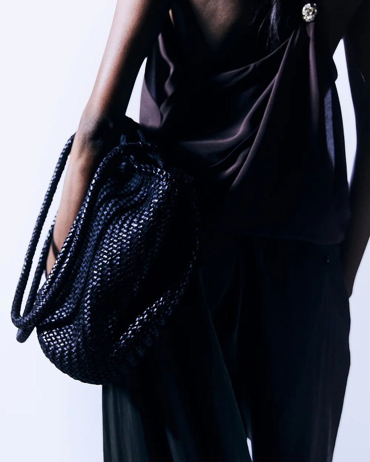 Close-up of the ALEO Romy Woven Tote in Black carried on the arm by a model