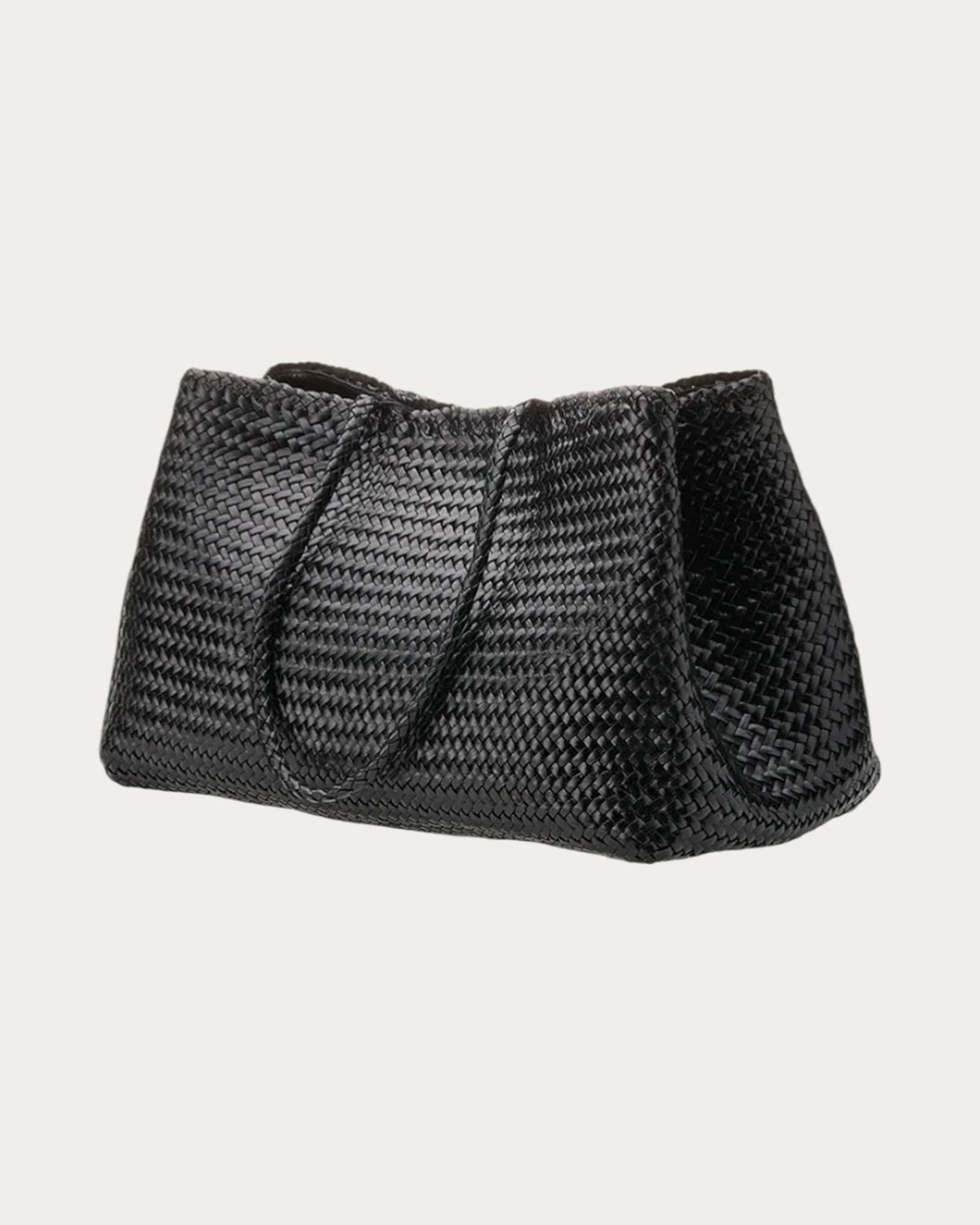 ALEO Romy Woven Tote in Black, three-quarter view showing the woven side, on soft stone background