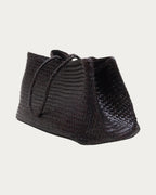 ALEO Romy Woven Tote in Crema, three-quarter view showing the woven side, on soft stone background