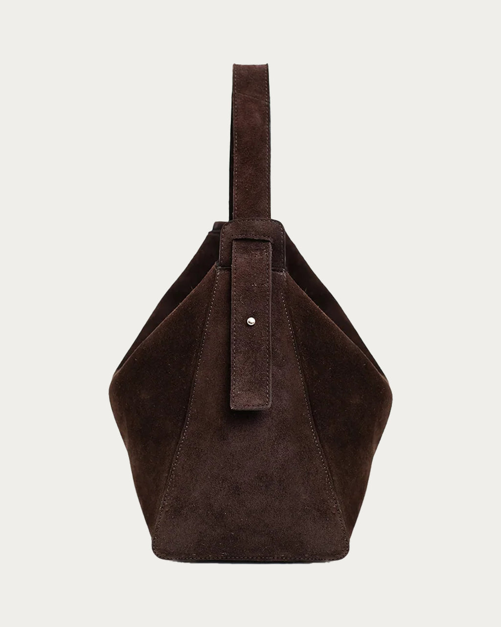 ALEO Shiloh Suede Shoulder Bag in Crema, side view showing the strap, on soft stone background