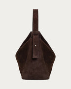 ALEO Shiloh Suede Shoulder Bag in Crema, side view showing the strap, on soft stone background