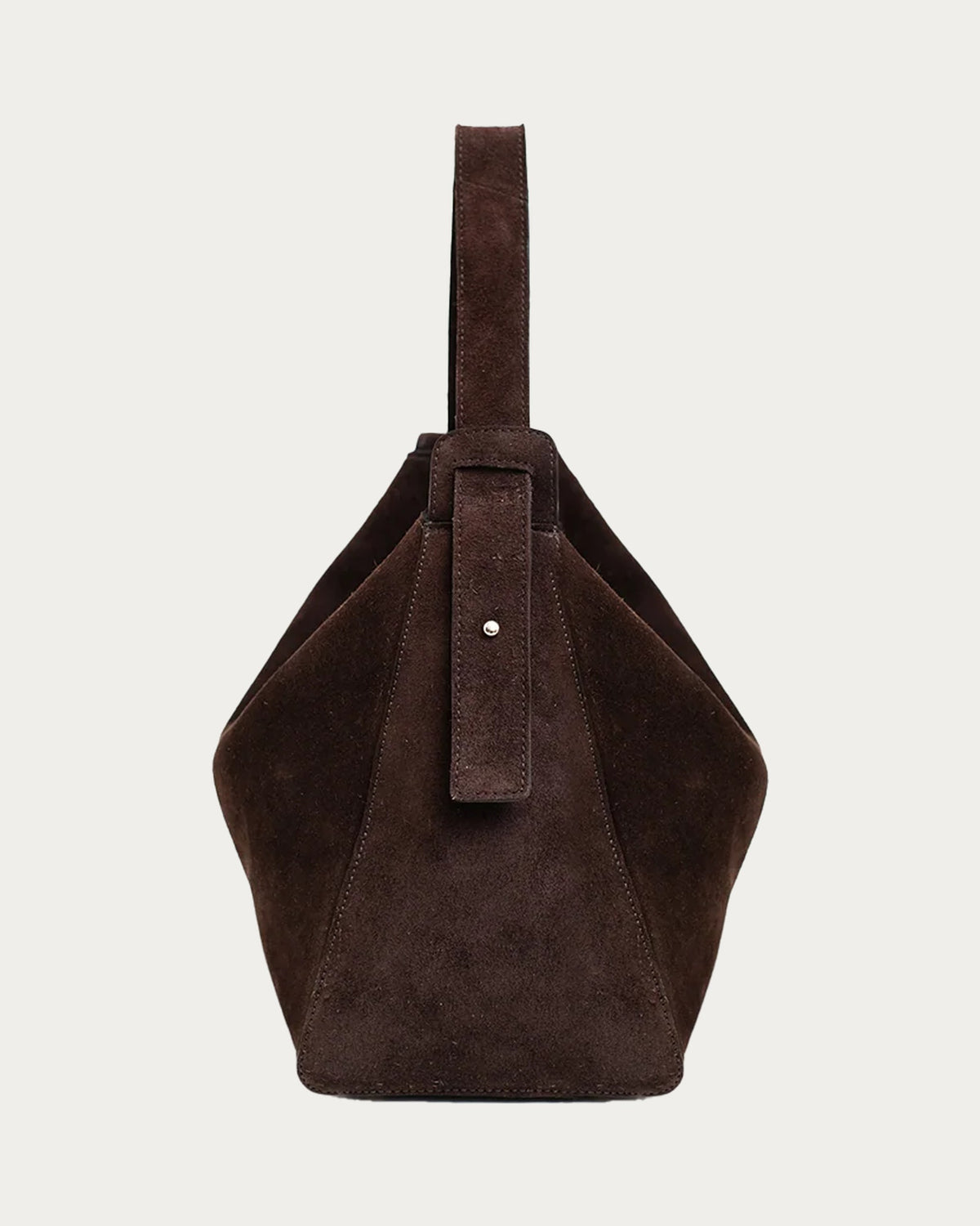 ALEO Shiloh Suede Shoulder Bag in Crema, side view showing the strap, on soft stone background