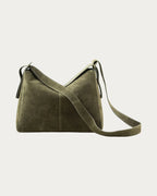 ALEO Shiloh Suede Shoulder Bag in Olive, front view with the long crossbody strap, on soft stone background
