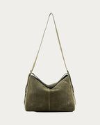 ALEO Shiloh Suede Shoulder Bag in Olive, front view with the long strap raised, on soft stone background