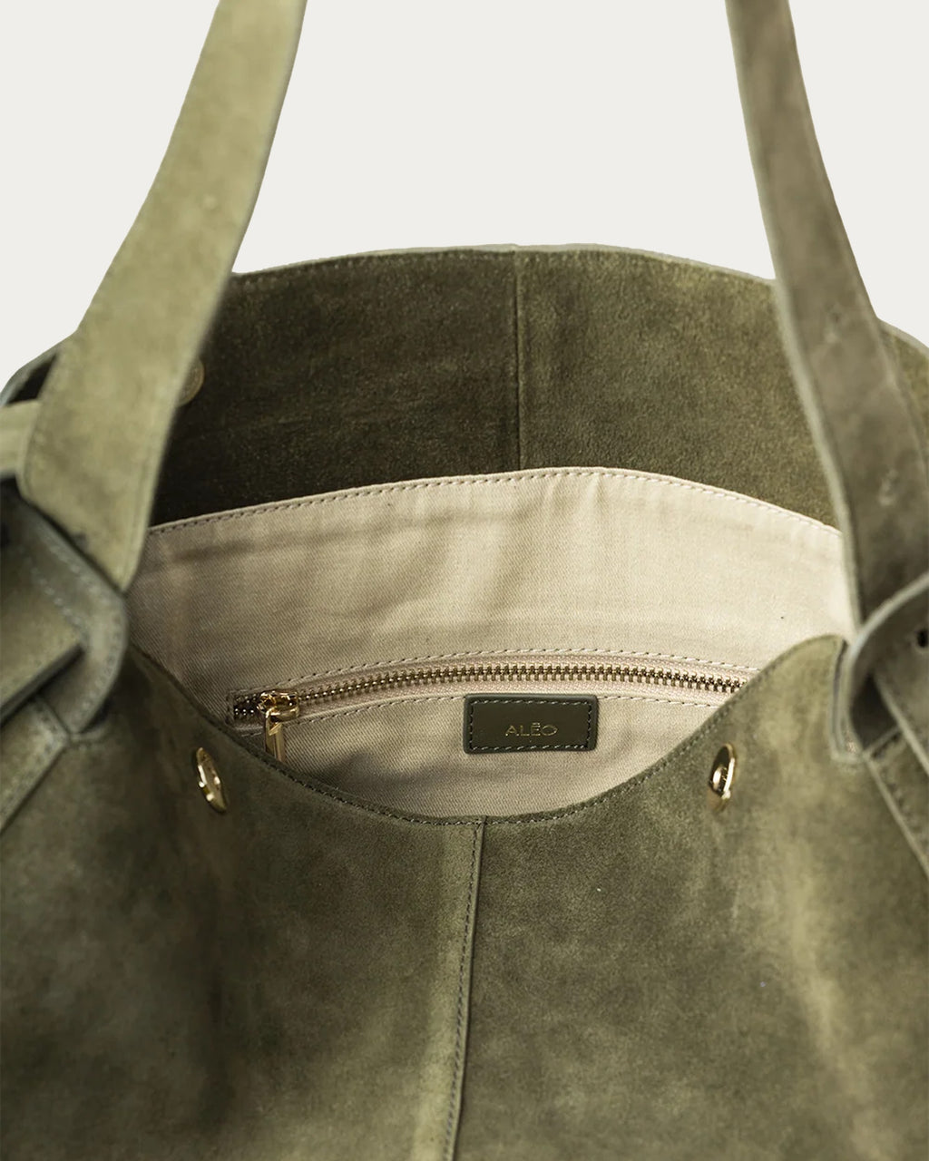 ALEO Shiloh Suede Shoulder Bag in Olive, interior close-up of the cotton lining, zip pocket and ALEO label