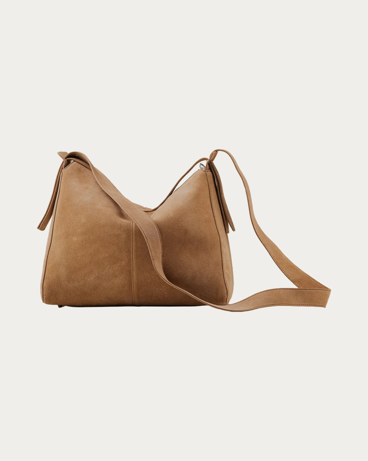 ALEO Shiloh Suede Shoulder Bag in Toffee with the cross-body strap laid out beside the bag, on soft stone background