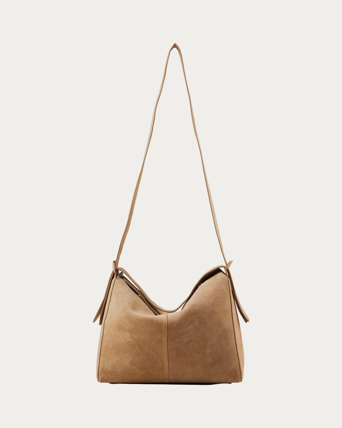 ALEO Shiloh Suede Shoulder Bag in Toffee, front view with the long cross-body strap, on soft stone background