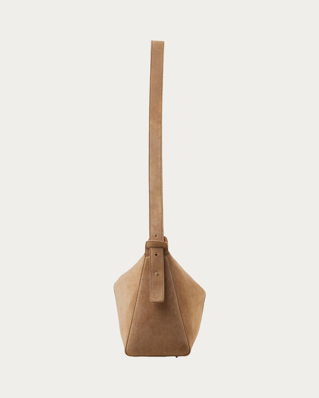 ALEO Shiloh Suede Shoulder Bag in Toffee, side view with the long cross-body strap, on soft stone background