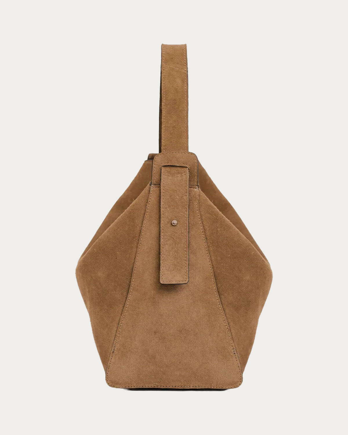 ALEO Shiloh Suede Shoulder Bag in Toffee, side view showing the buckled shoulder strap, on soft stone background