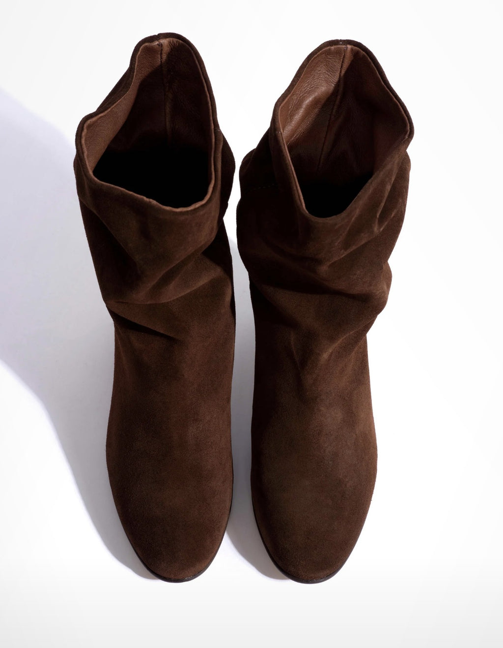 Pair of Anonymous Copenhagen Lully 55 chocolate suede boots from above showing the leather lining