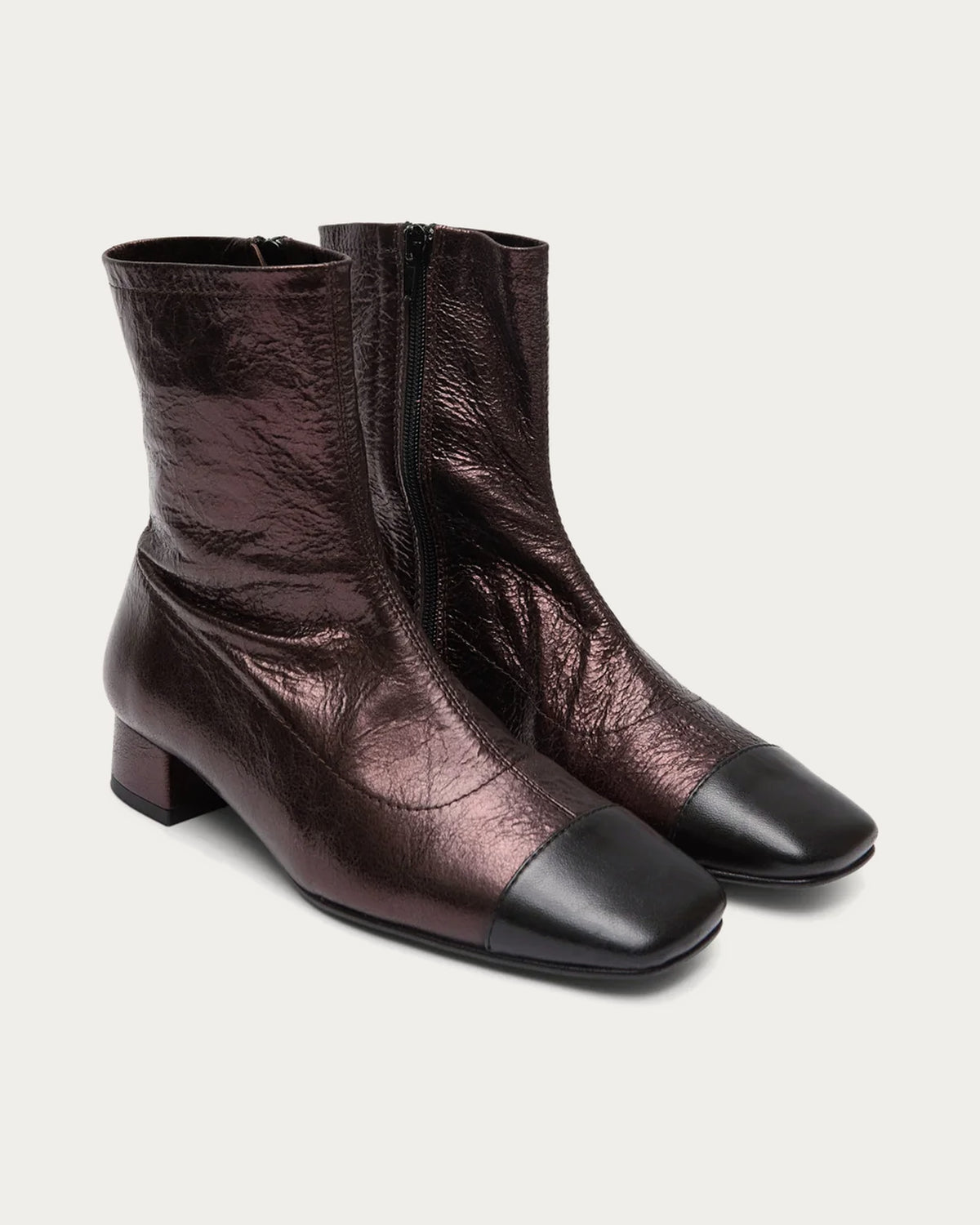 Pair of Augusta chocolate metallic leather ankle boots with contrasted toe, angled view