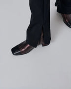 Close-up of model wearing Augusta chocolate metallic leather ankle boots