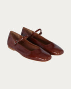 Pair of Augusta saddle patent leather Mary Jane flats with square toe, angled view