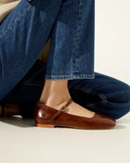 Side view of Augusta saddle patent leather Mary Jane flat worn with dark blue jeans