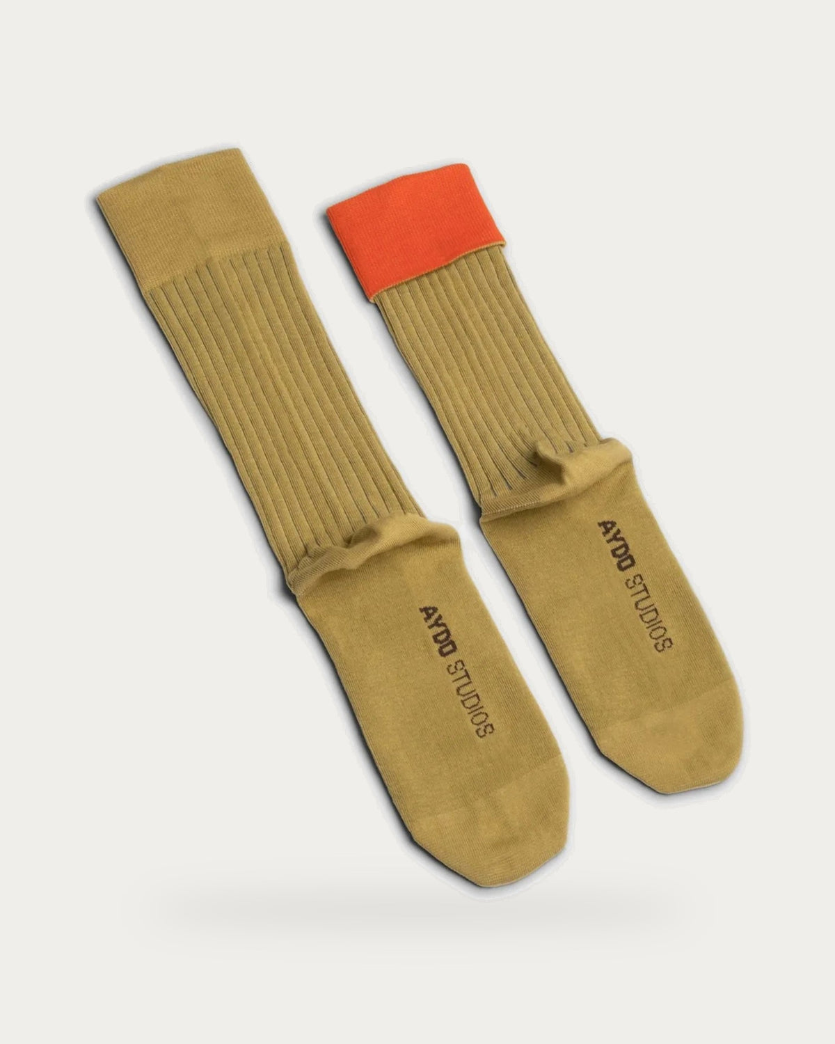 Aydo Studios Lublin Rhythm Rust Pulse Socks – pair of socks on soft stone background
