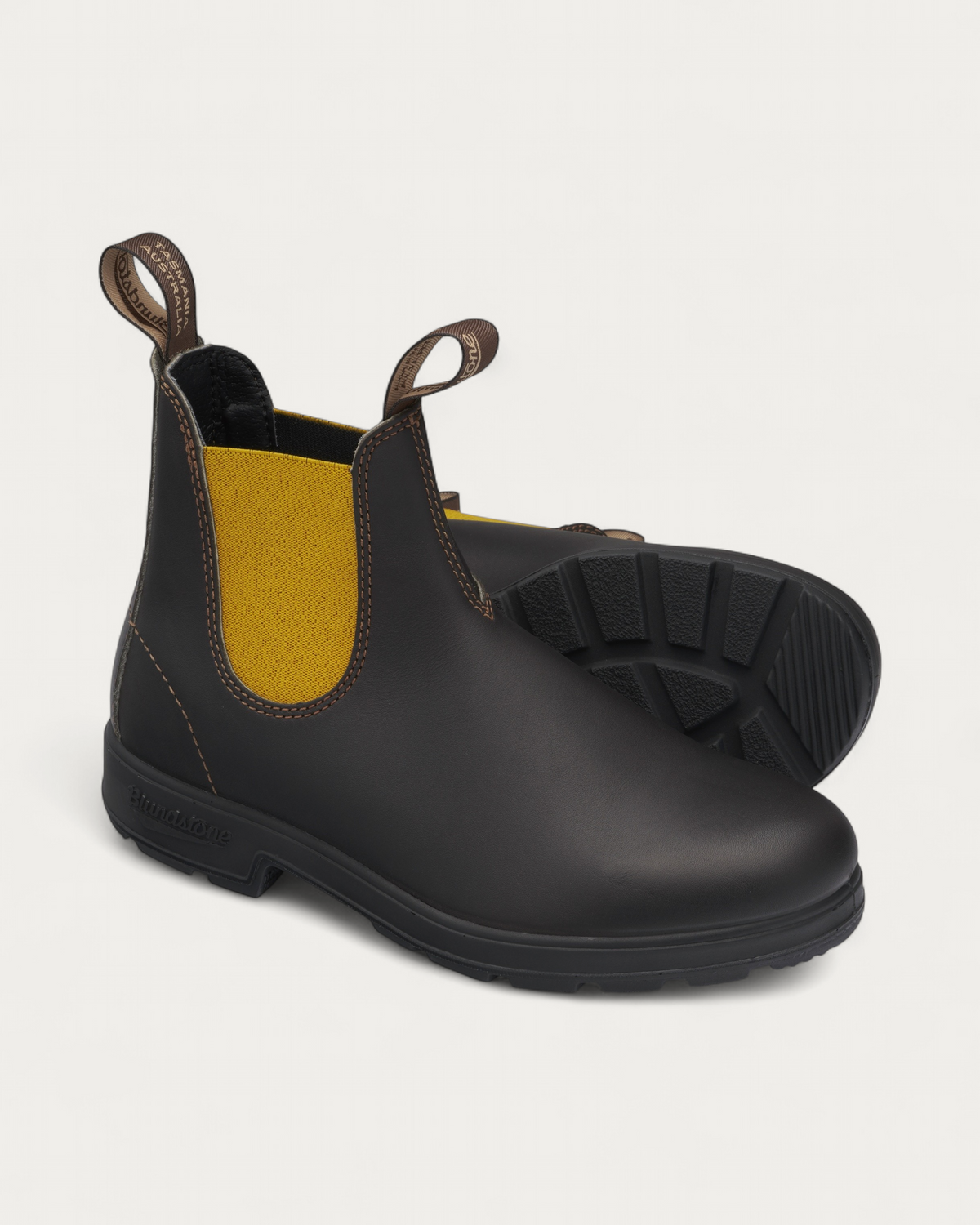 Pair of Blundstone 1919 Brown with Mustard Chelsea Boots showing the outsole tread