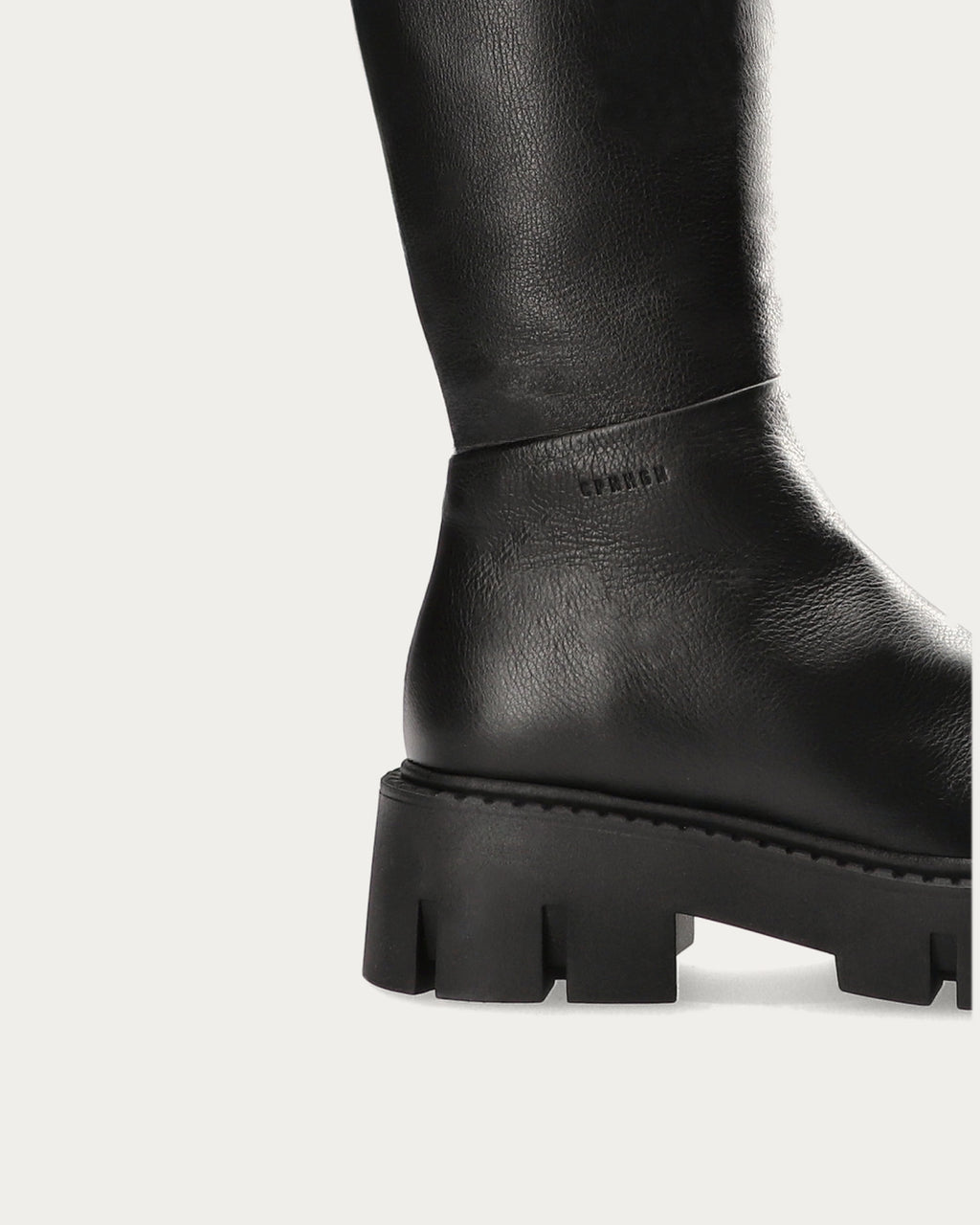 Close-up of the side logo and grooved platform sole on the Copenhagen Studios black leather knee high boot