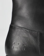 Copenhagen Studios black leather ankle boot, close-up of the heel and embossed logo