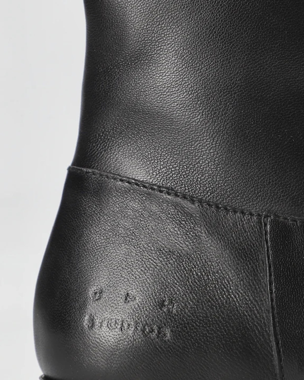 Copenhagen Studios black leather ankle boot, close-up of the heel and embossed logo