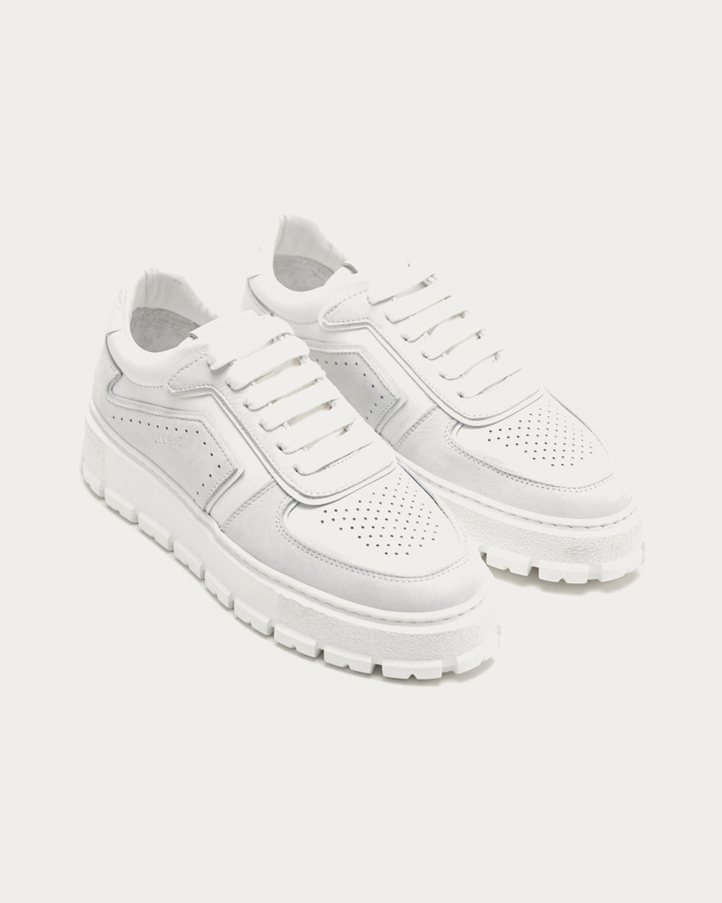 Pair of Copenhagen Studios white leather platform sneakers, three-quarter view with white laces