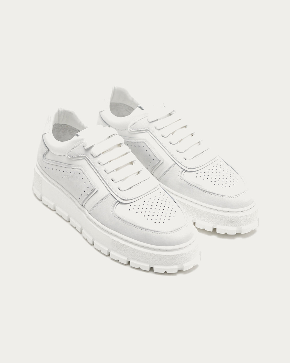 Pair of Copenhagen Studios white leather platform sneakers, three-quarter view with white laces