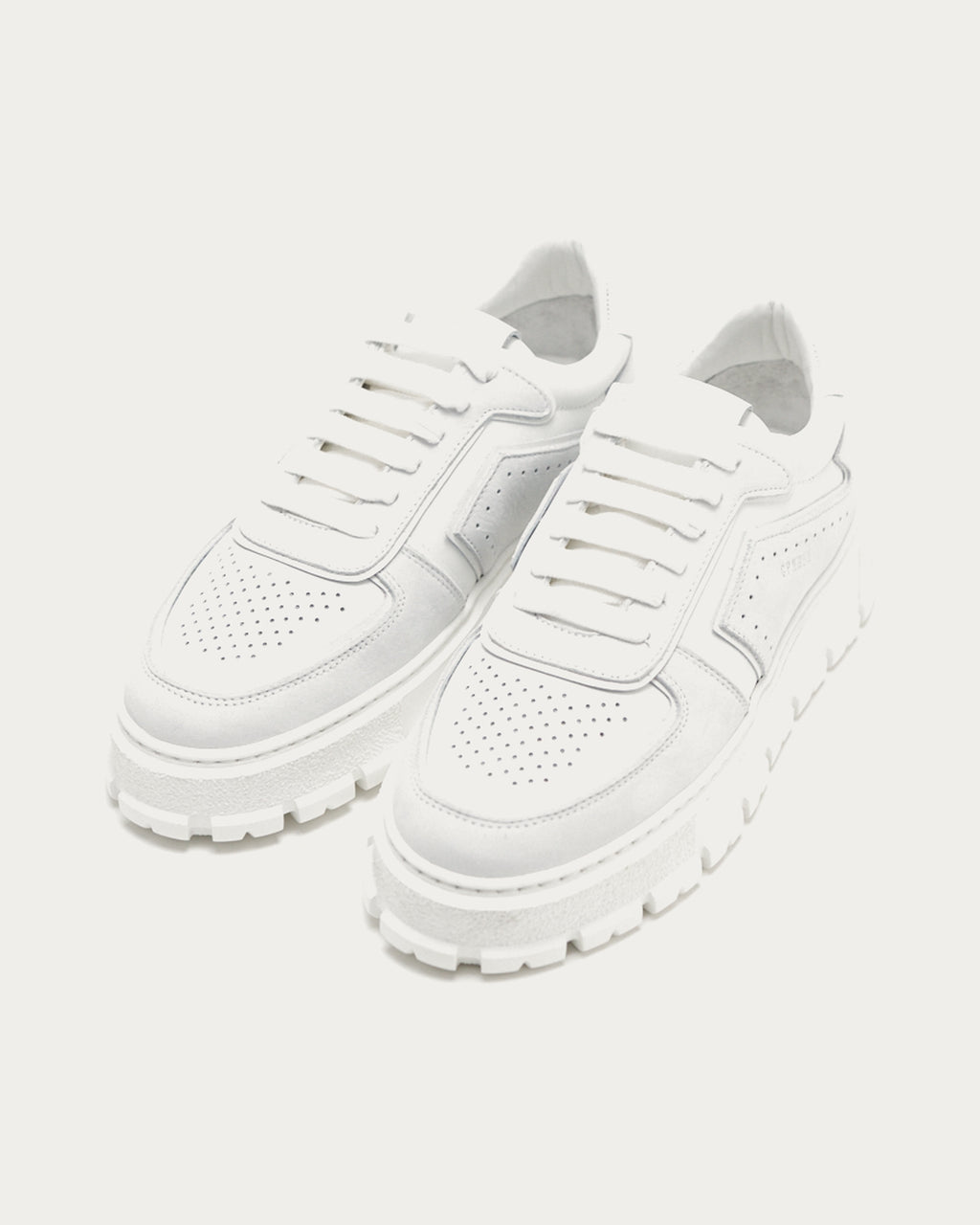 Pair of Copenhagen Studios white platform sneakers, angled view of perforated toe caps