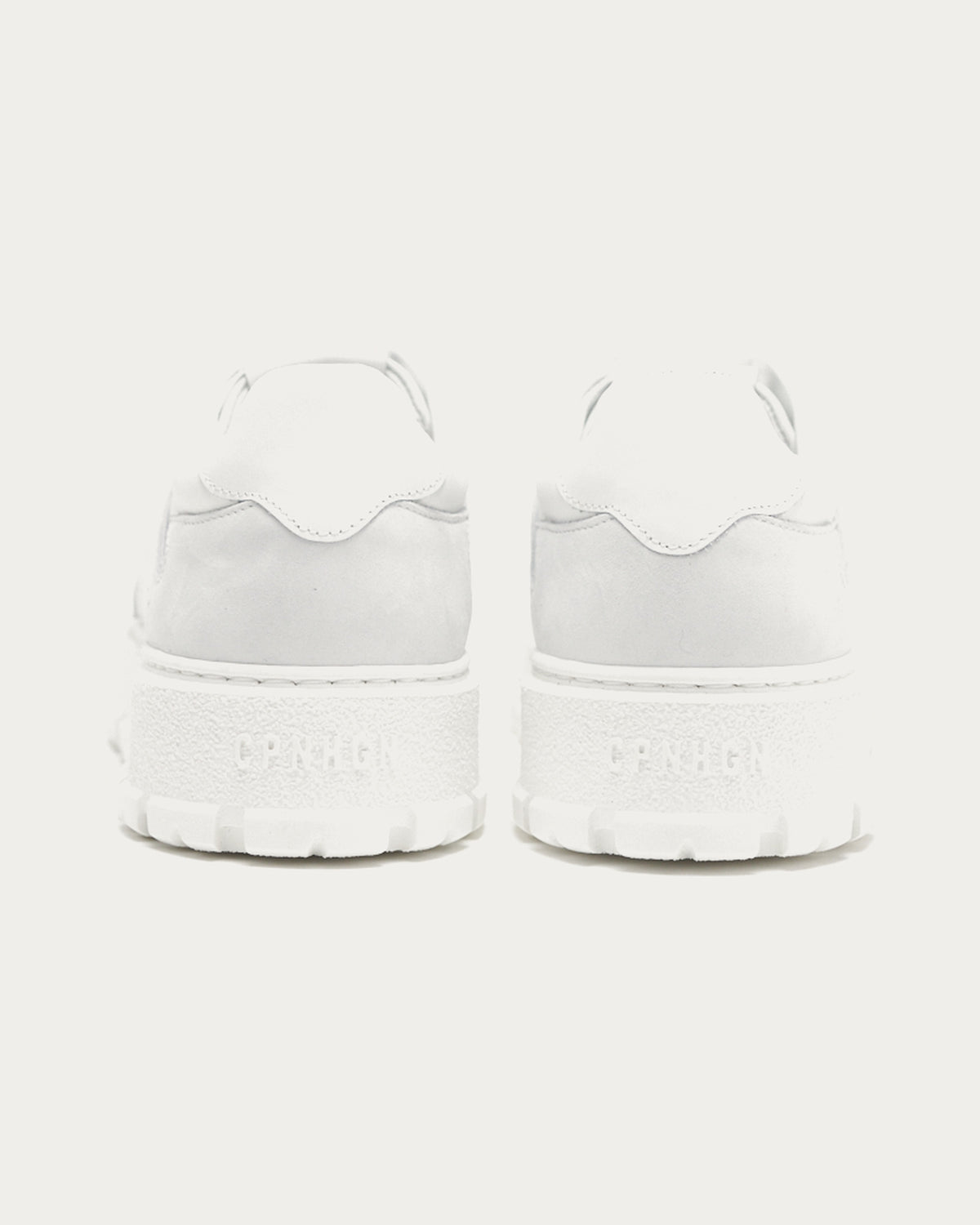 Pair of Copenhagen Studios white platform sneakers, back view with embossed heel logo