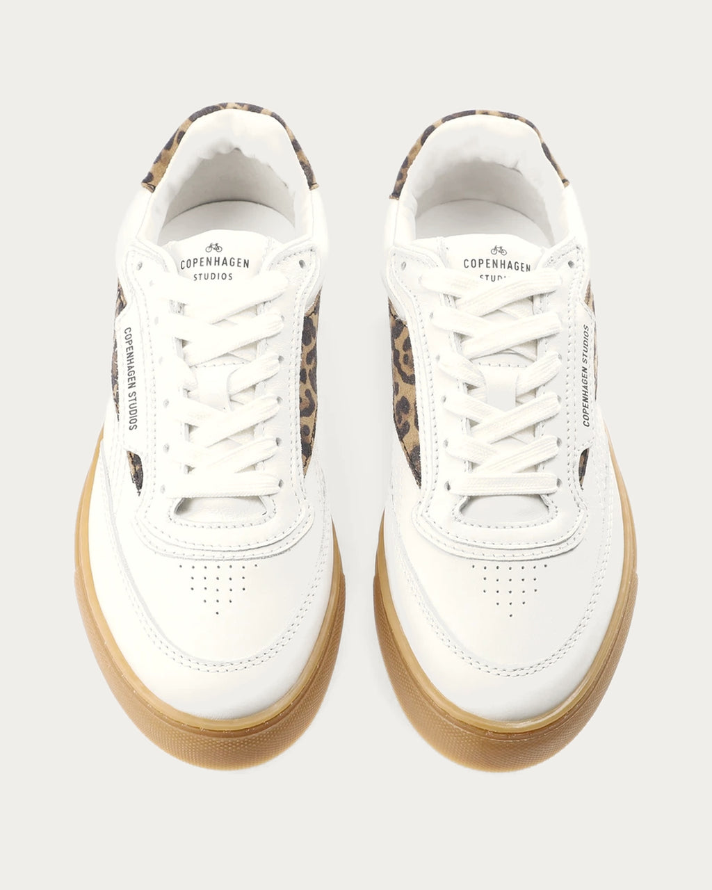 Pair of Copenhagen Studios white leather sneakers with leopard panels and white laces, top view