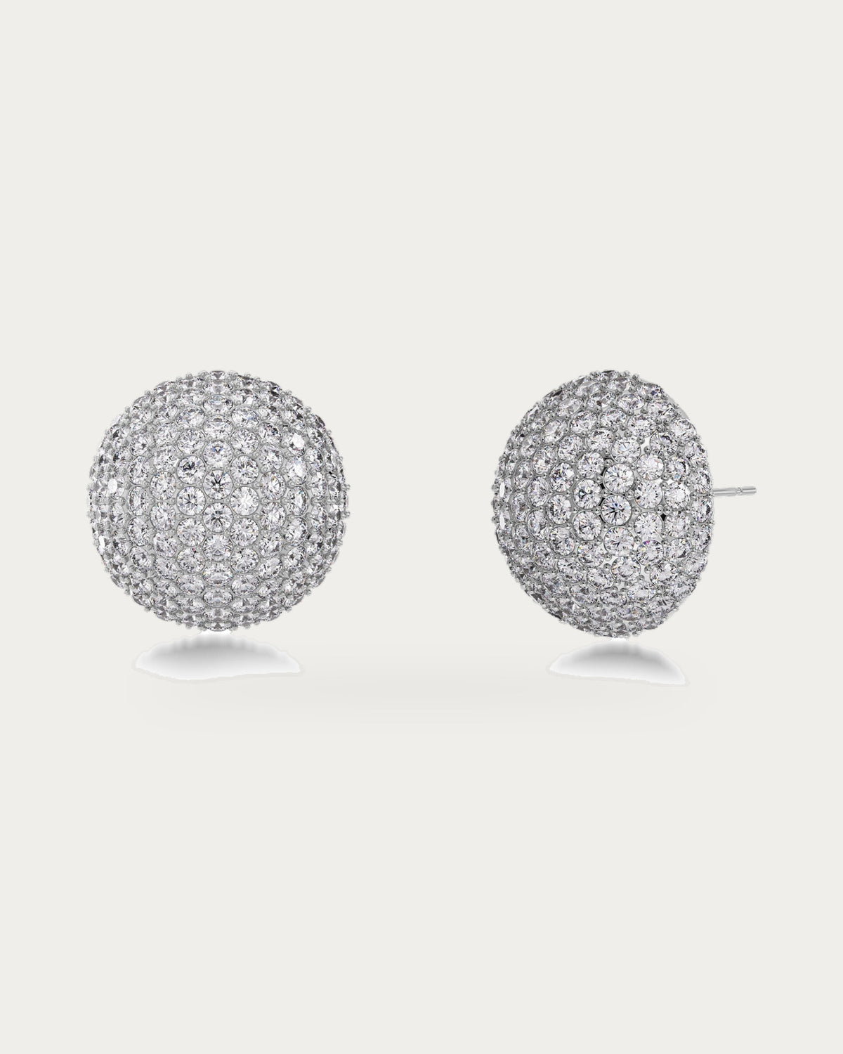 Edblad Bead Sparkle Stud Earrings In Steel, a pair of round steel stud earrings covered in clear sparkling stones, product photo on a soft off-white background