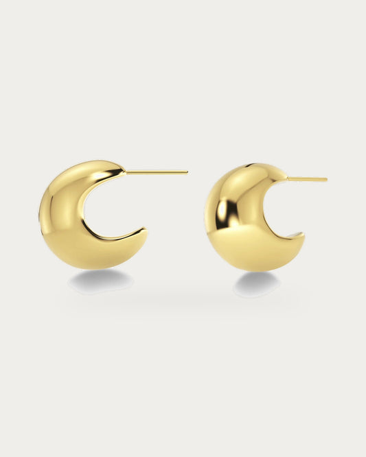 Edblad Bold Small Creole Earrings In Gold, a pair of small round gold creole earrings, product photo on a soft off-white background