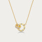 Edblad Ida Mini Necklace In Gold, close-up of the interlocked gold ring pendant set with clear stones on the fine chain