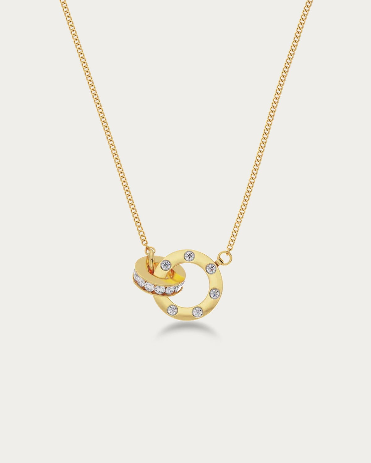 Edblad Ida Mini Necklace In Gold, close-up of the interlocked gold ring pendant set with clear stones on the fine chain