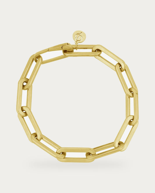 Edblad Ivy Maxi Bracelet In Gold, a gold bracelet made of large rectangular chain links, product photo on a soft off-white background