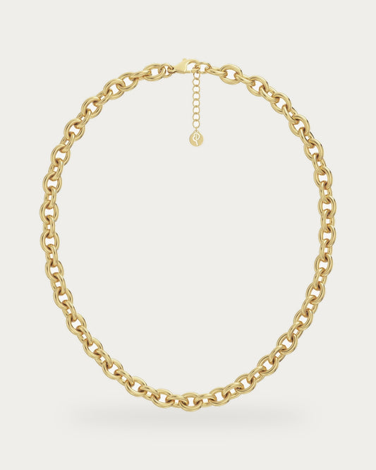 Edblad Loop Link Necklace In Gold, a gold chain necklace with chunky round links and an extender chain, product photo on a soft off-white background