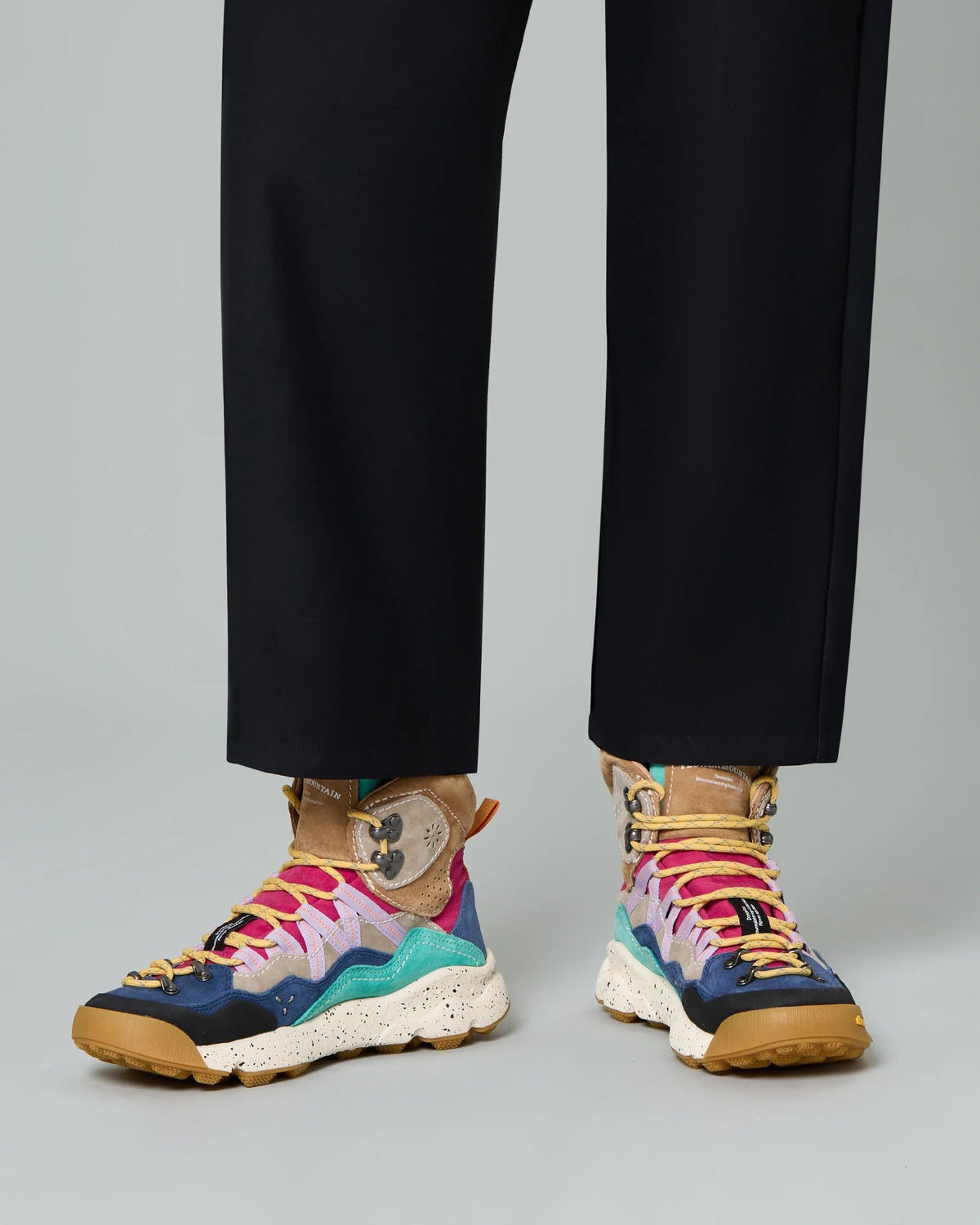 Model wearing Flower Mountain Bankei Blue Petrol boots with black trousers