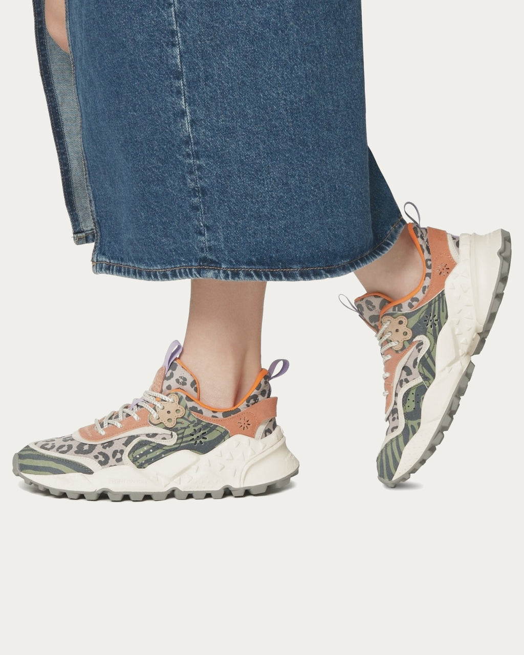Model wearing Flower Mountain Kotetsu Woman Sage Tan sneakers with a denim skirt