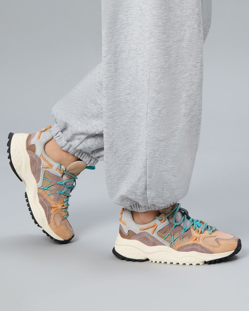 Model wearing Flower Mountain Yamabushi 1M51 sneakers with grey joggers