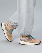 Model wearing Flower Mountain Yamabushi 1M51 sneakers with grey joggers