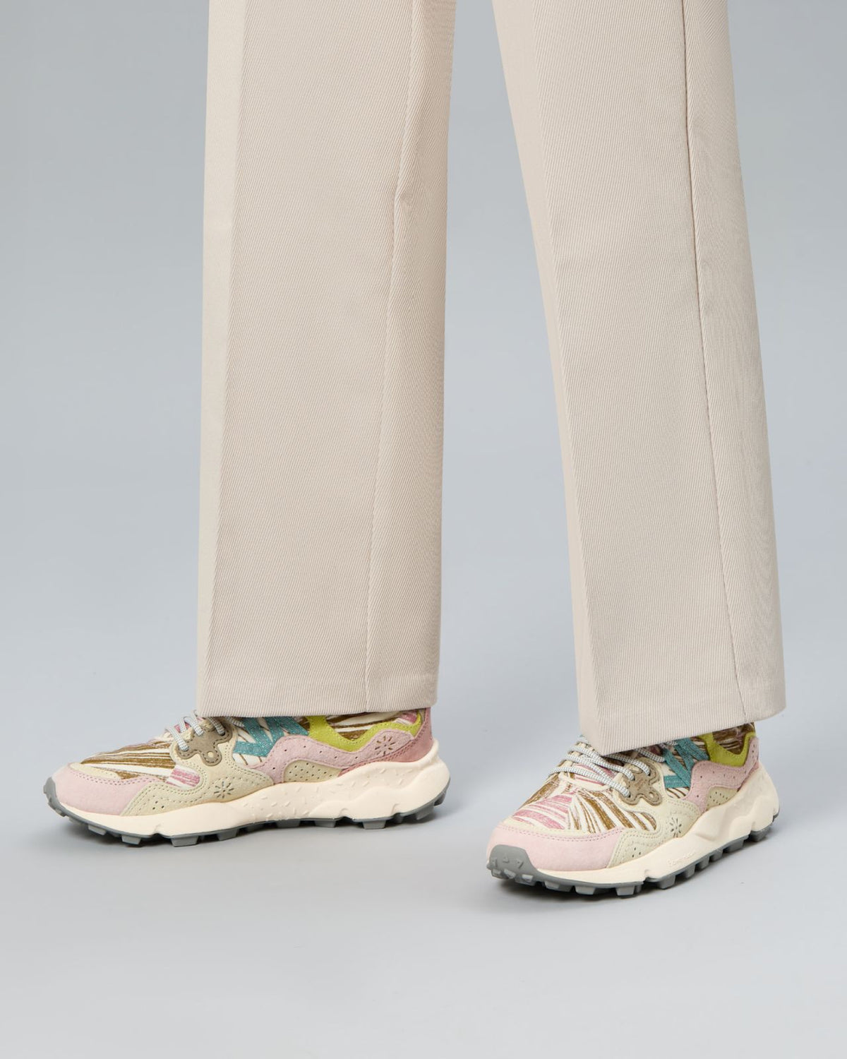 Model wearing Flower Mountain Yamano Painted sneakers with cream trousers