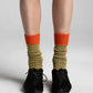 Aydo Studios Lublin Rhythm socks in Rust Pulse, worn with cuff folded