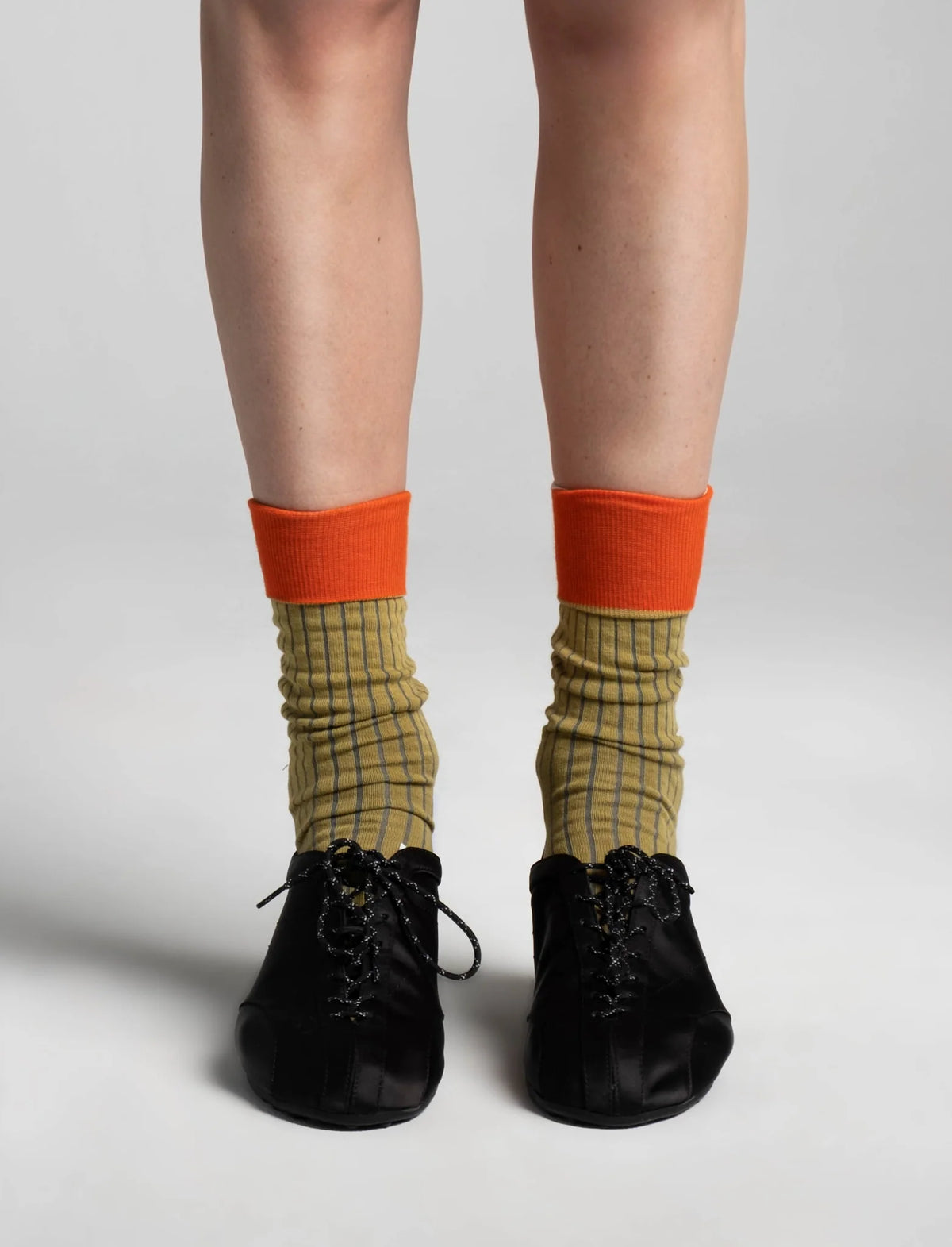Aydo Studios Lublin Rhythm socks in Rust Pulse, worn with cuff folded