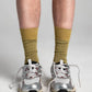 Aydo Studios Lublin Rhythm socks in Rust Pulse, worn with trainers