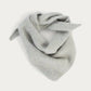 Le Bonnet Wool Bandana in Silver, a light grey knotted wool bandana, product photo on a soft off-white background