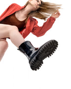 Model wearing Lemon Jelly City black waterproof rain boot, low-angle lifestyle shot