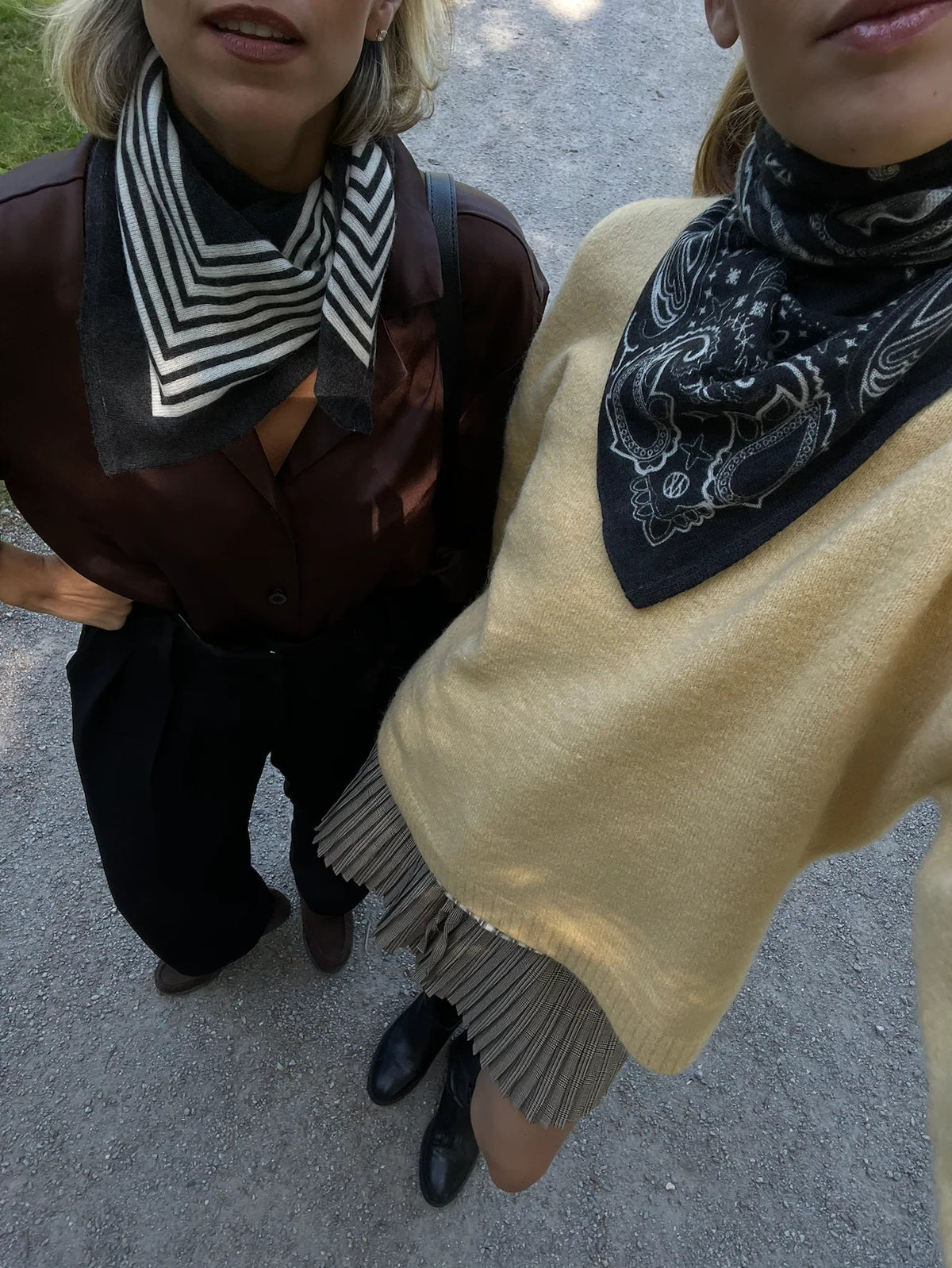 Lescarf cashmere paisley scarf in black with cream print, worn with a yellow knit