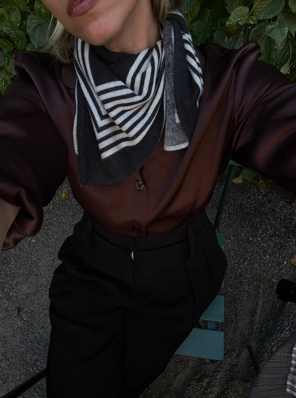 Lescarf cashmere striped scarf in black and cream, worn at the neck with a brown satin shirt