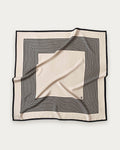 No.1 in Sand scarf by Lescarf, 90x90 cm, laid flat in sand with black concentric stripes and a black border