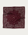 Lescarf Paisley Scarf in Wine Red, flat lay showing the white paisley print and border on wine red silk
